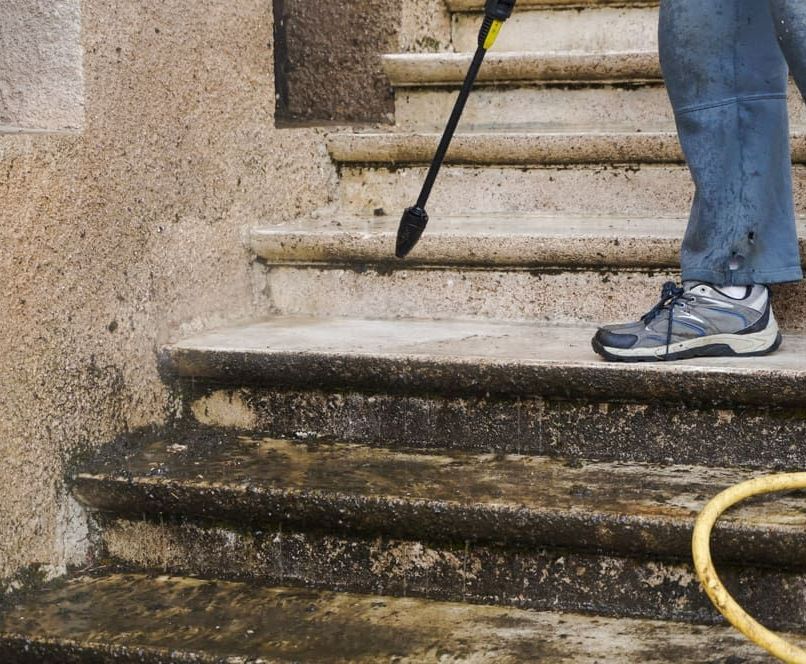 Person is Cleaning a Set of Stairs With a High Pressure Washer — Happy Housekeepers in South Tamworth, NSW