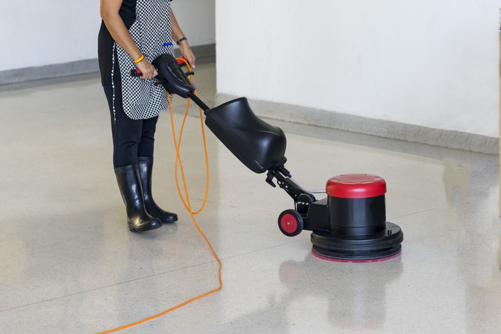 Woman is Cleaning the Floor With a Machine — Happy Housekeepers in South Tamworth, NSW
