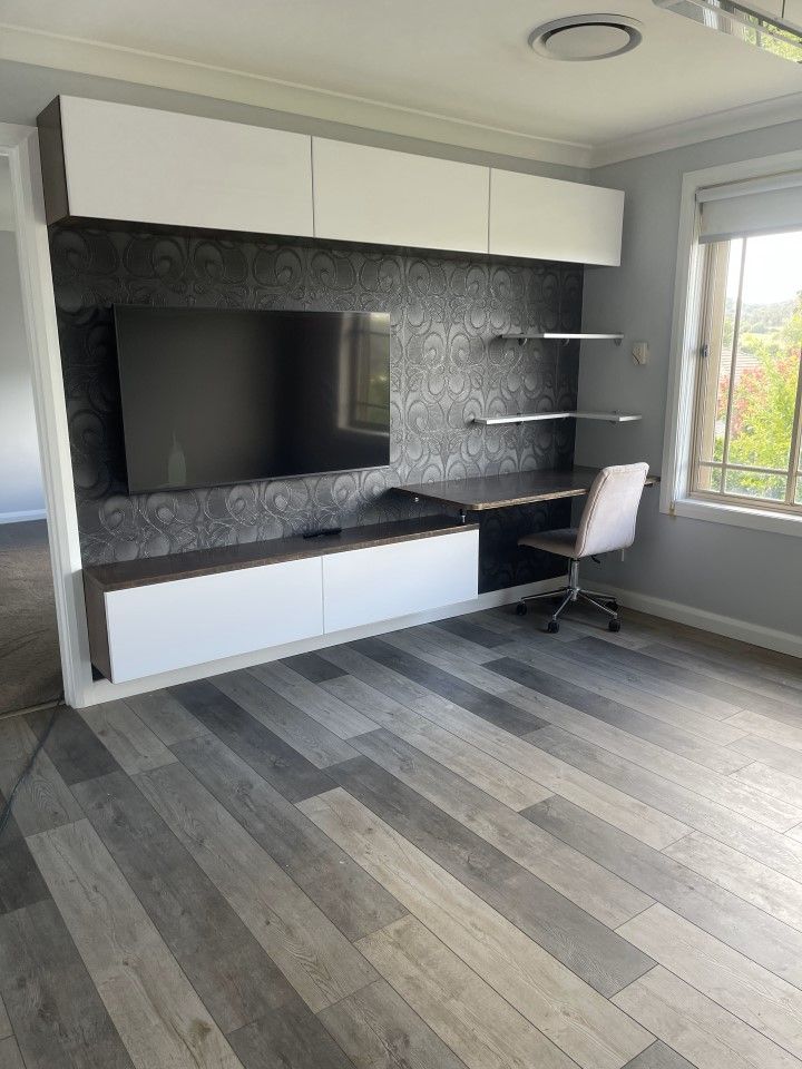 Living Room With Hardwood Floors , a Desk and a Flat Screen Tv — Happy Housekeepers in South Tamworth, NSW