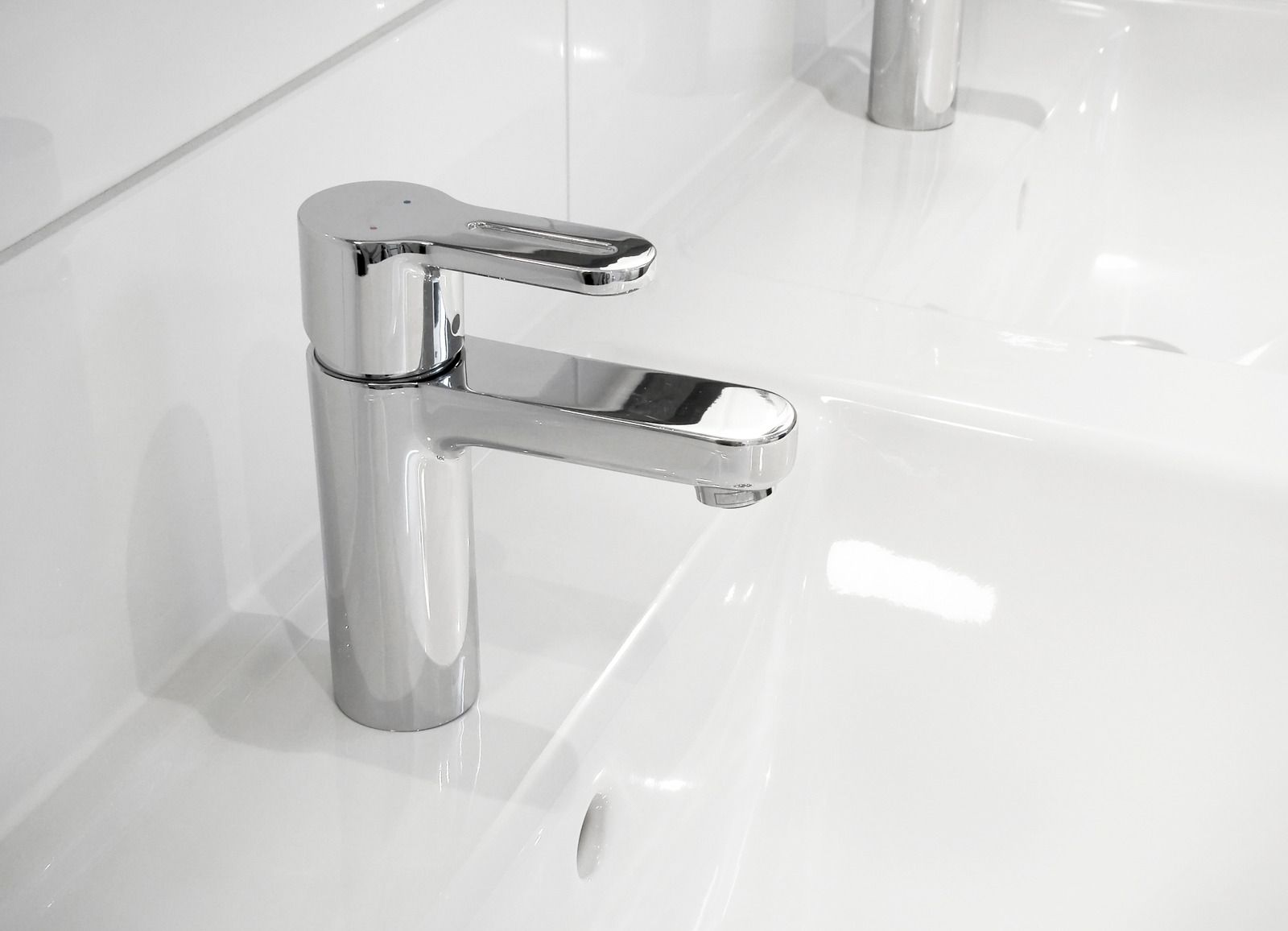 Chrome bathroom faucet over a white sink