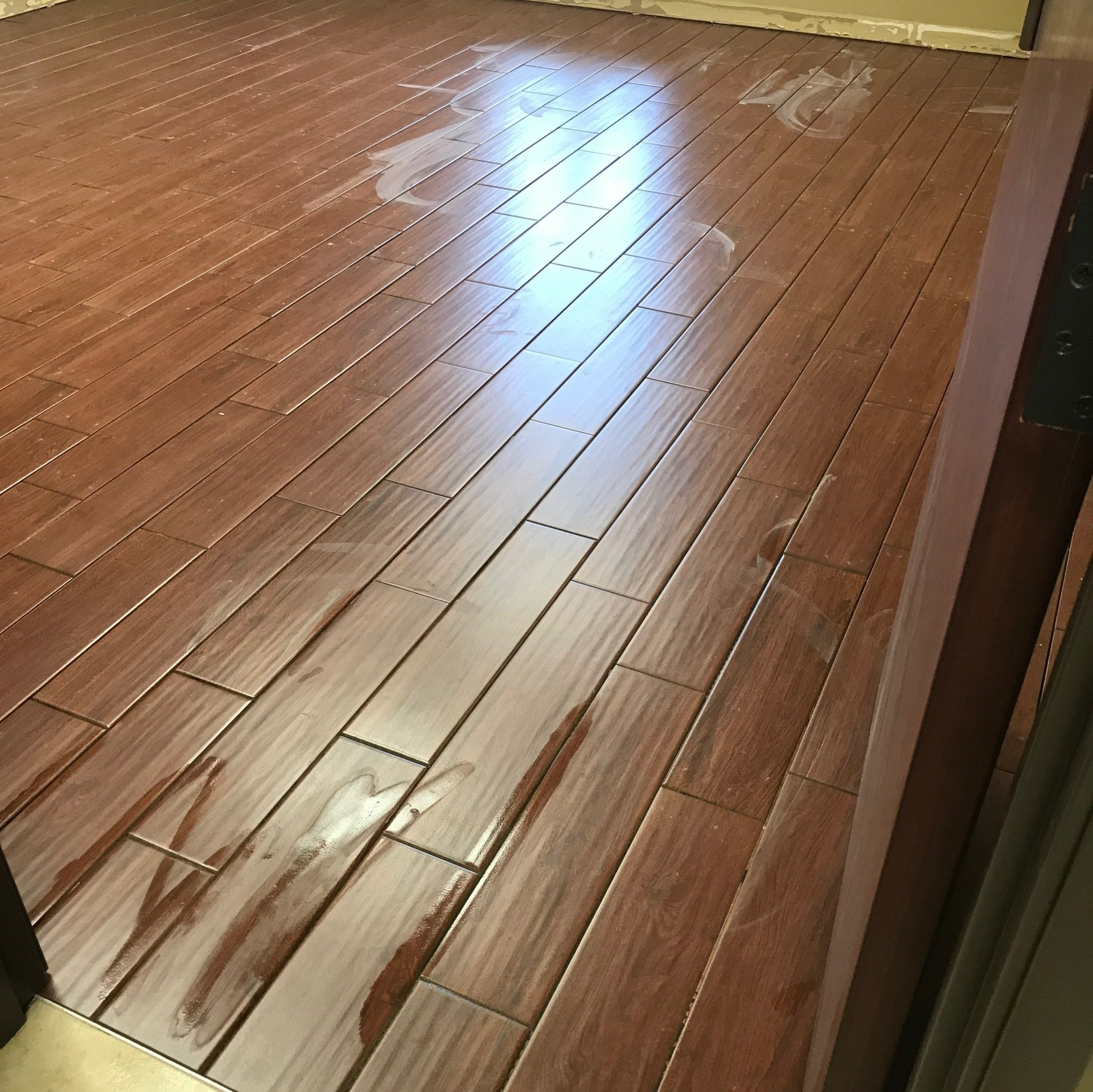 A wooden floor with a lot of stains on it