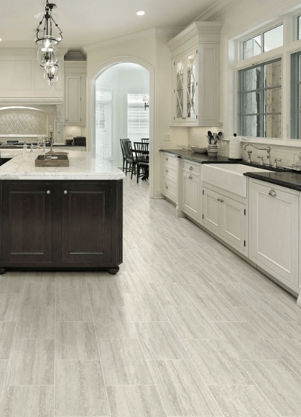 A kitchen with a large island and white cabinets