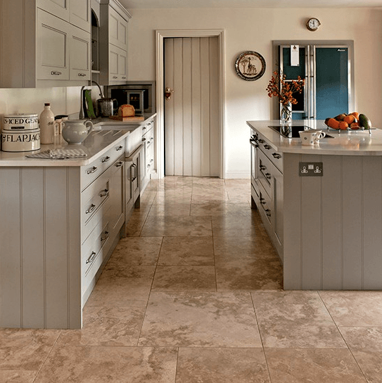 A kitchen with a large island and a clock on the wall