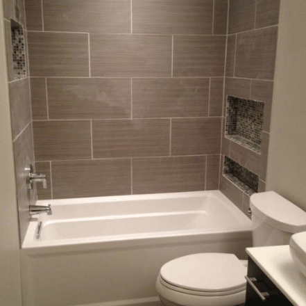 A bathroom with a tub , toilet , sink and shower.