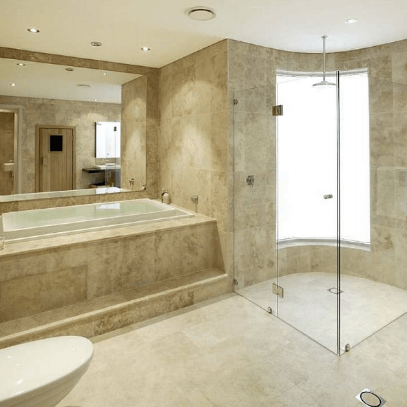A bathroom with a toilet a tub and a shower