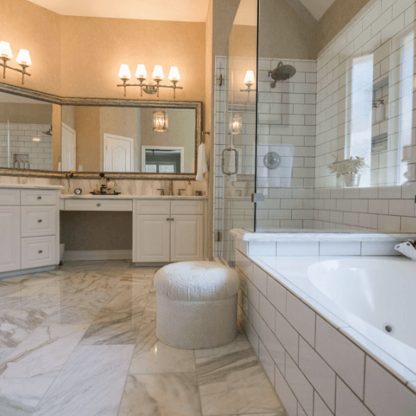 A bathroom with a tub and a large mirror