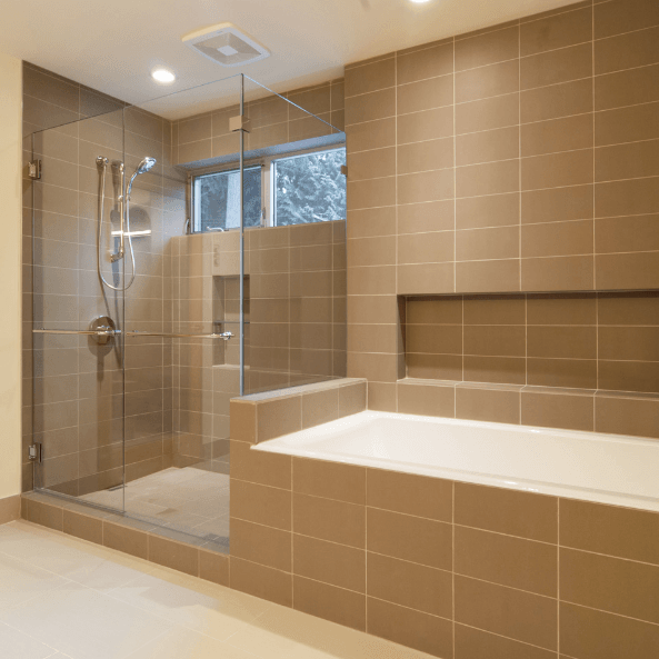 A bathroom with a bathtub and a walk in shower