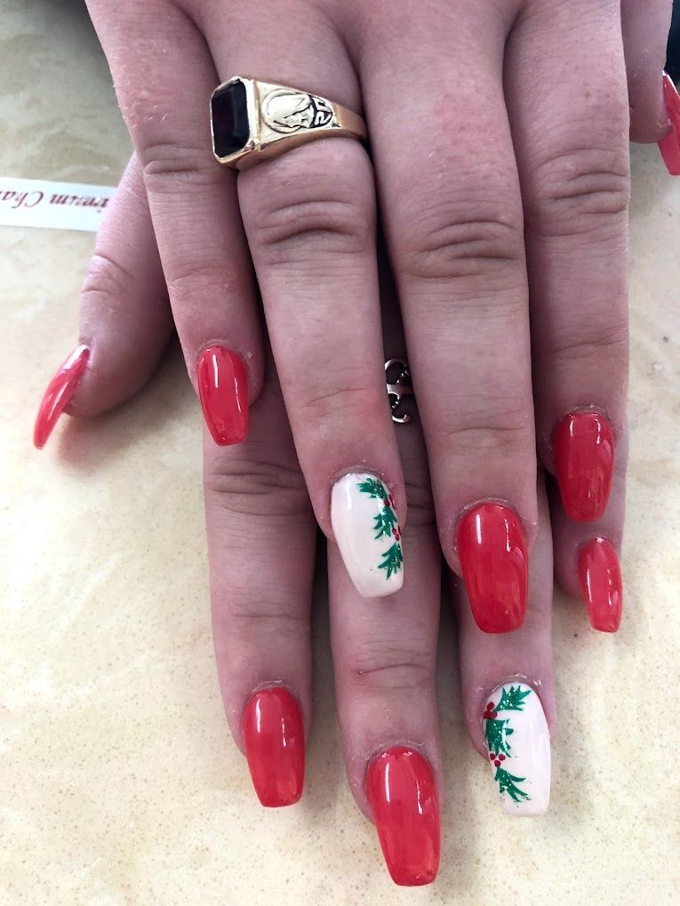 A woman 's hand with red nails and a gold ring