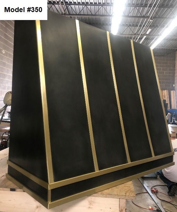 Large black and gold angled display panel in an industrial workshop or warehouse.