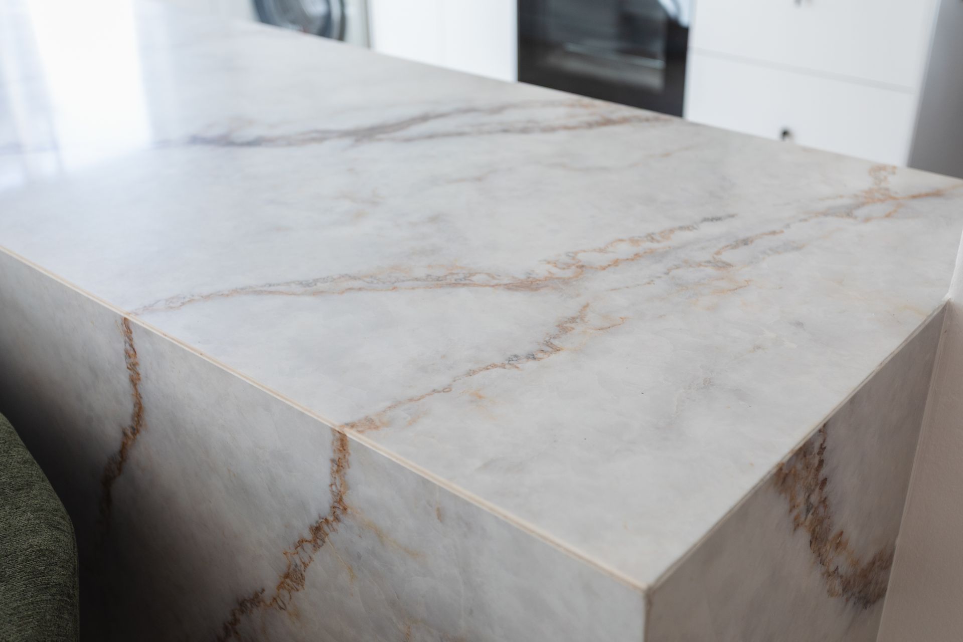White marble-look tabletop with beige veining in a modern interior
