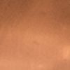 Close-up of a blurry orange-brown surface with a small bright highlight on the right edge