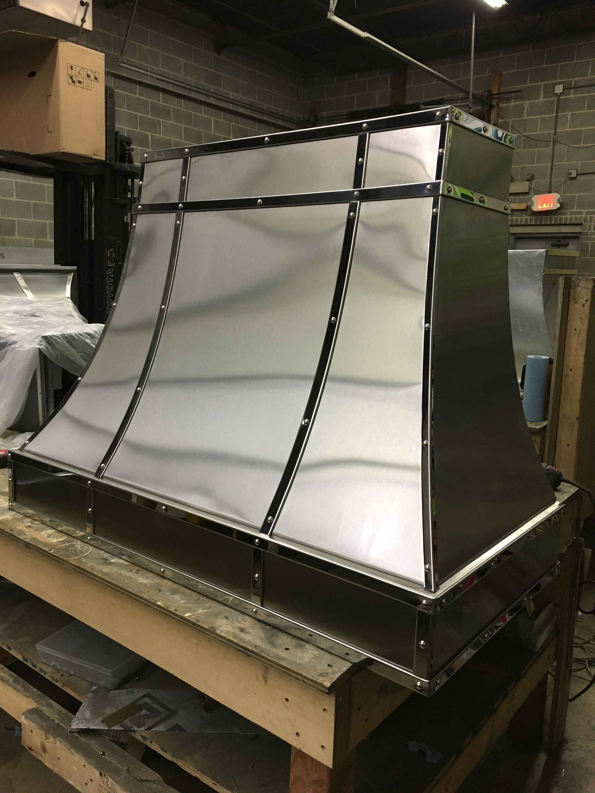 Metal sheet assembly with curved white panels on a warehouse pallet