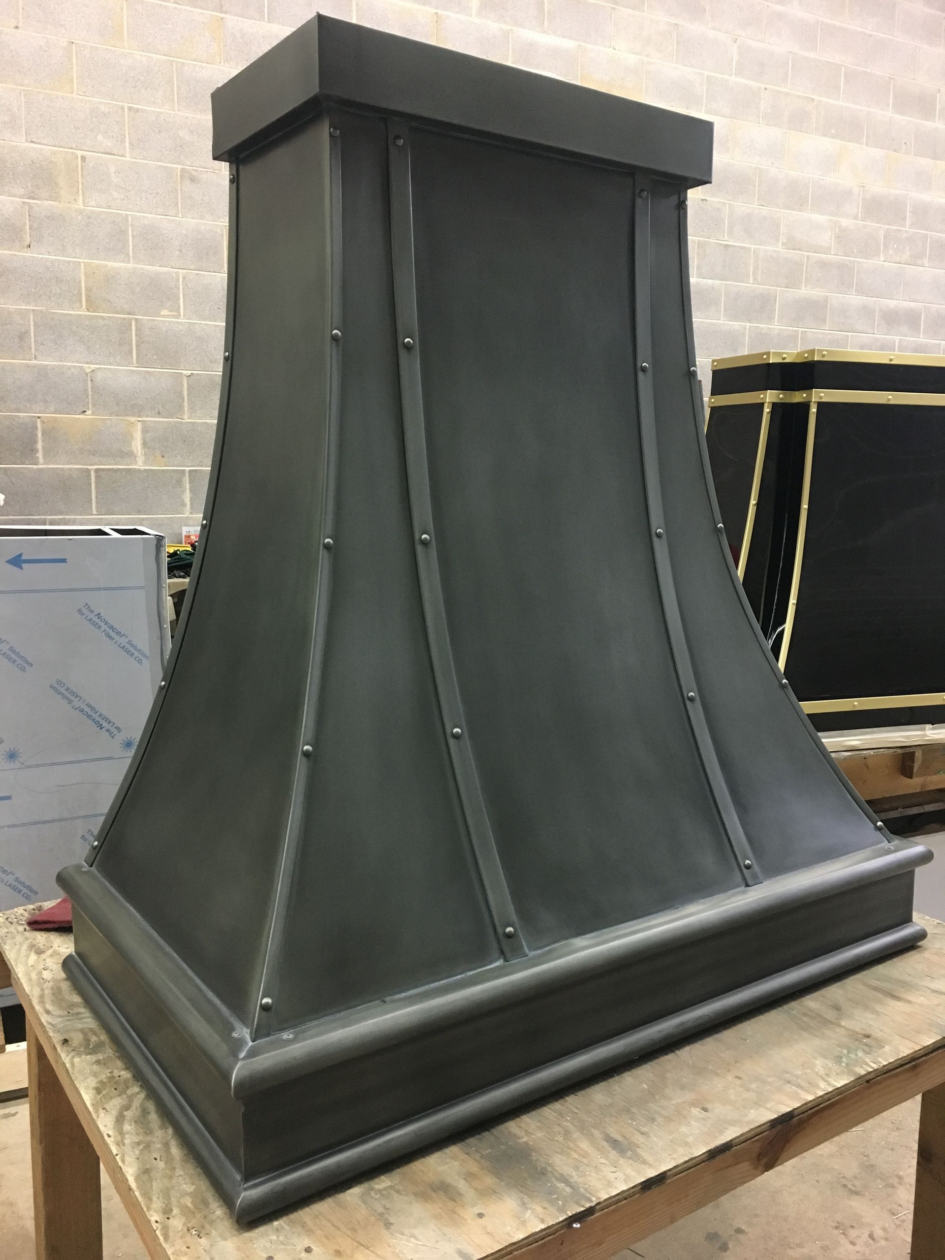 Black metal decorative column base on a workbench in a workshop