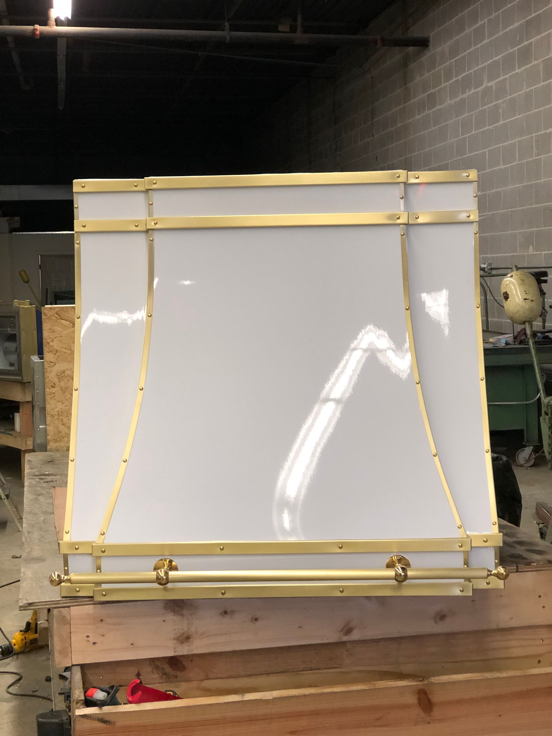 Large white panel strapped with yellow bands on a pallet in an industrial warehouse