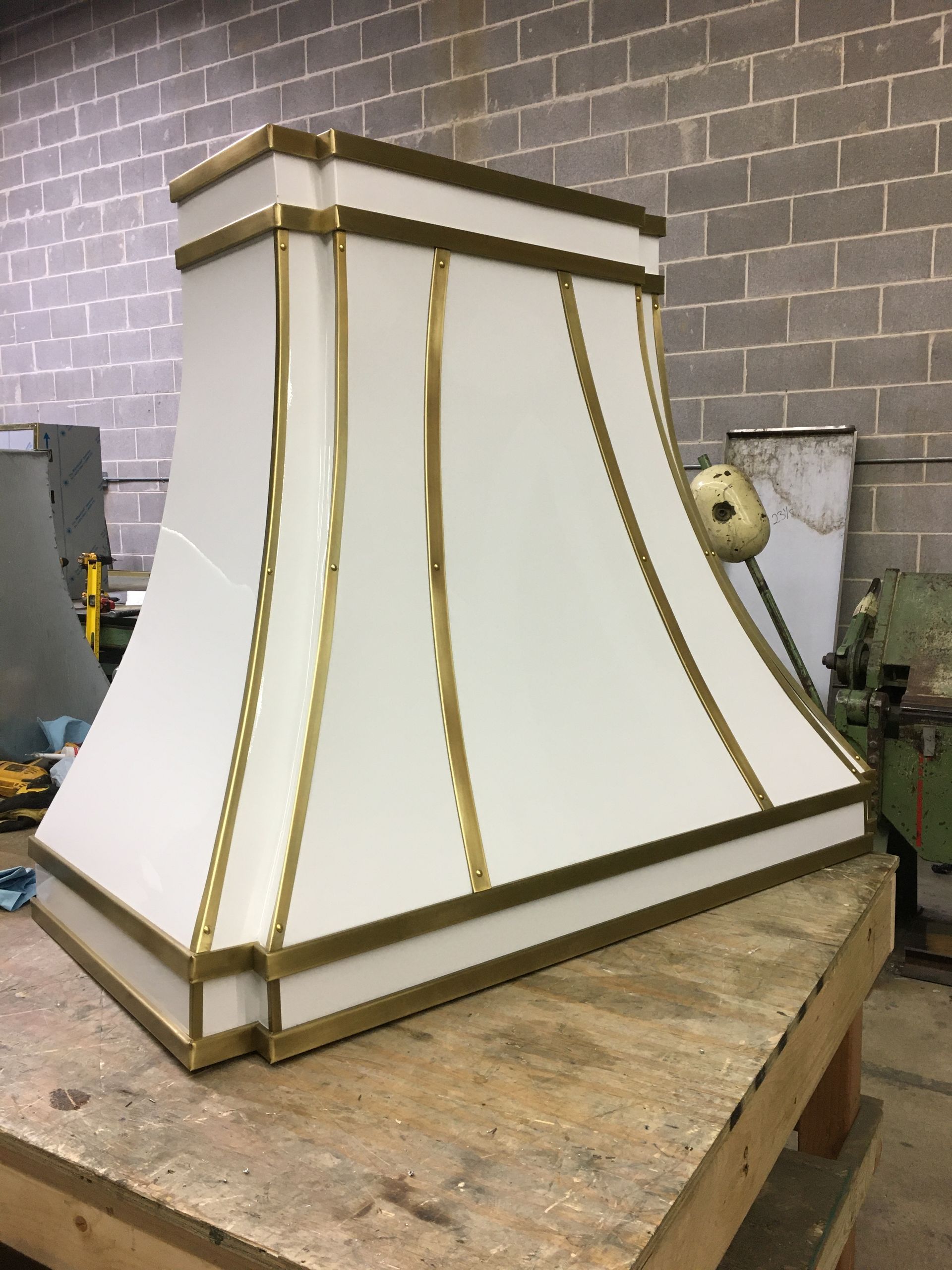 White and gold decorative lamp shade on a workbench in a workshop