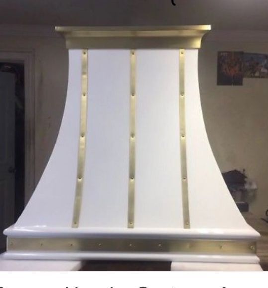 White and gold decorative pedestal or column-like structure against a wall indoors