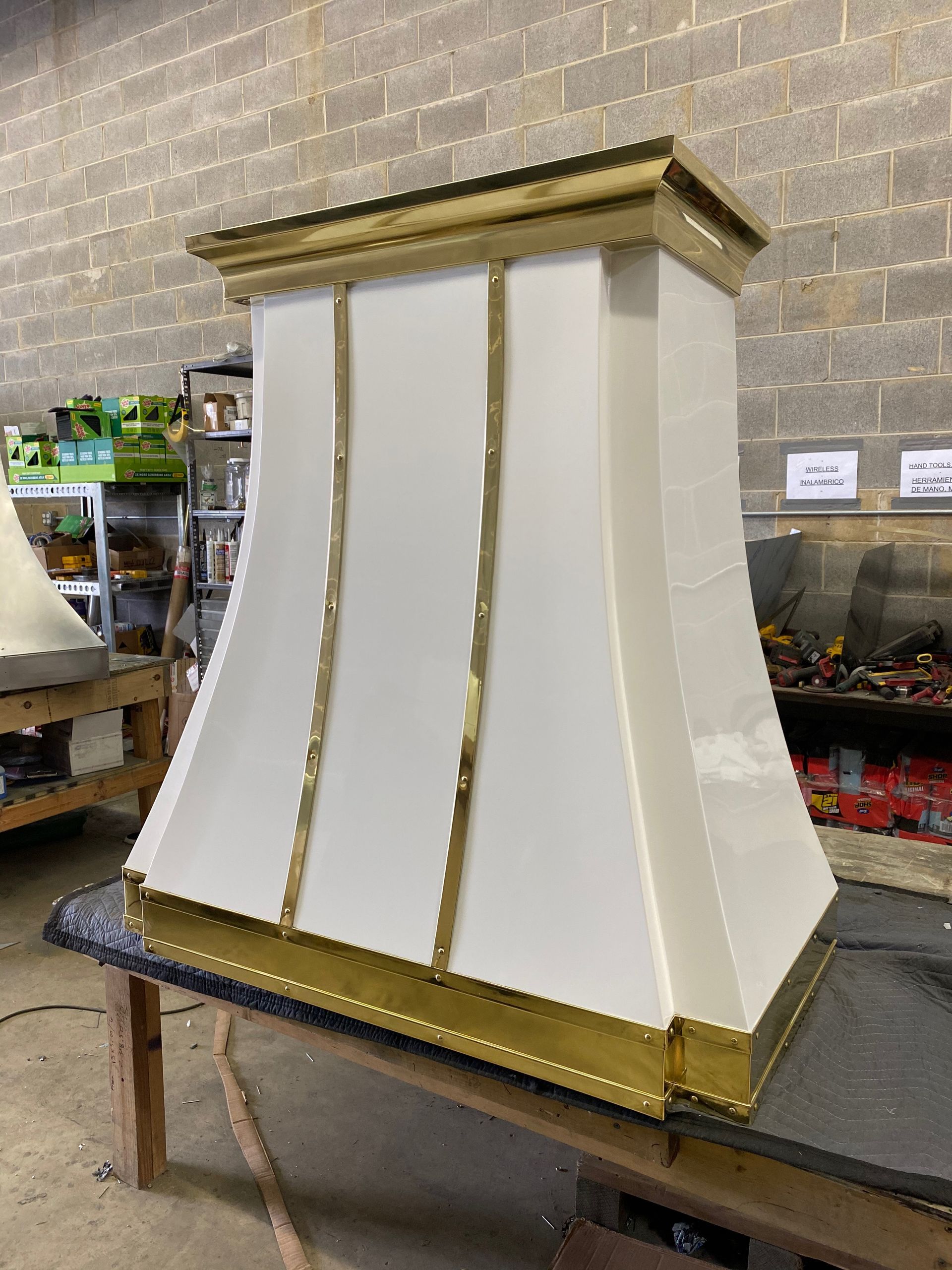 White and gold decorative wall or lamp cover on a worktable in a workshop