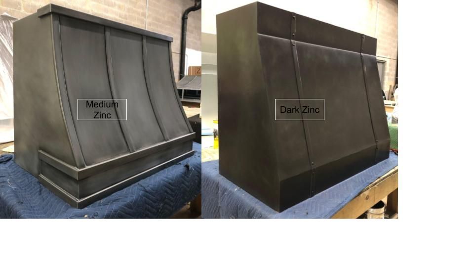 Side-by-side metal duct sections labeled “Mild steel zinc” and “Ducts,” on a workshop floor.