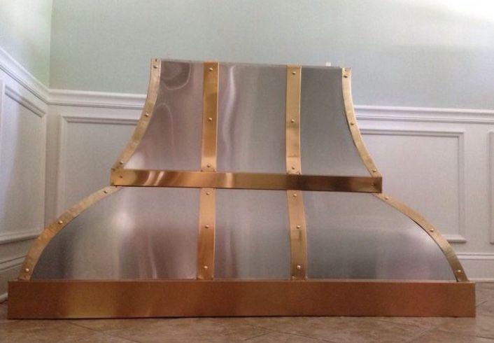 Decorative gold and silver metal lamp shade or fireplace screen in a corner room