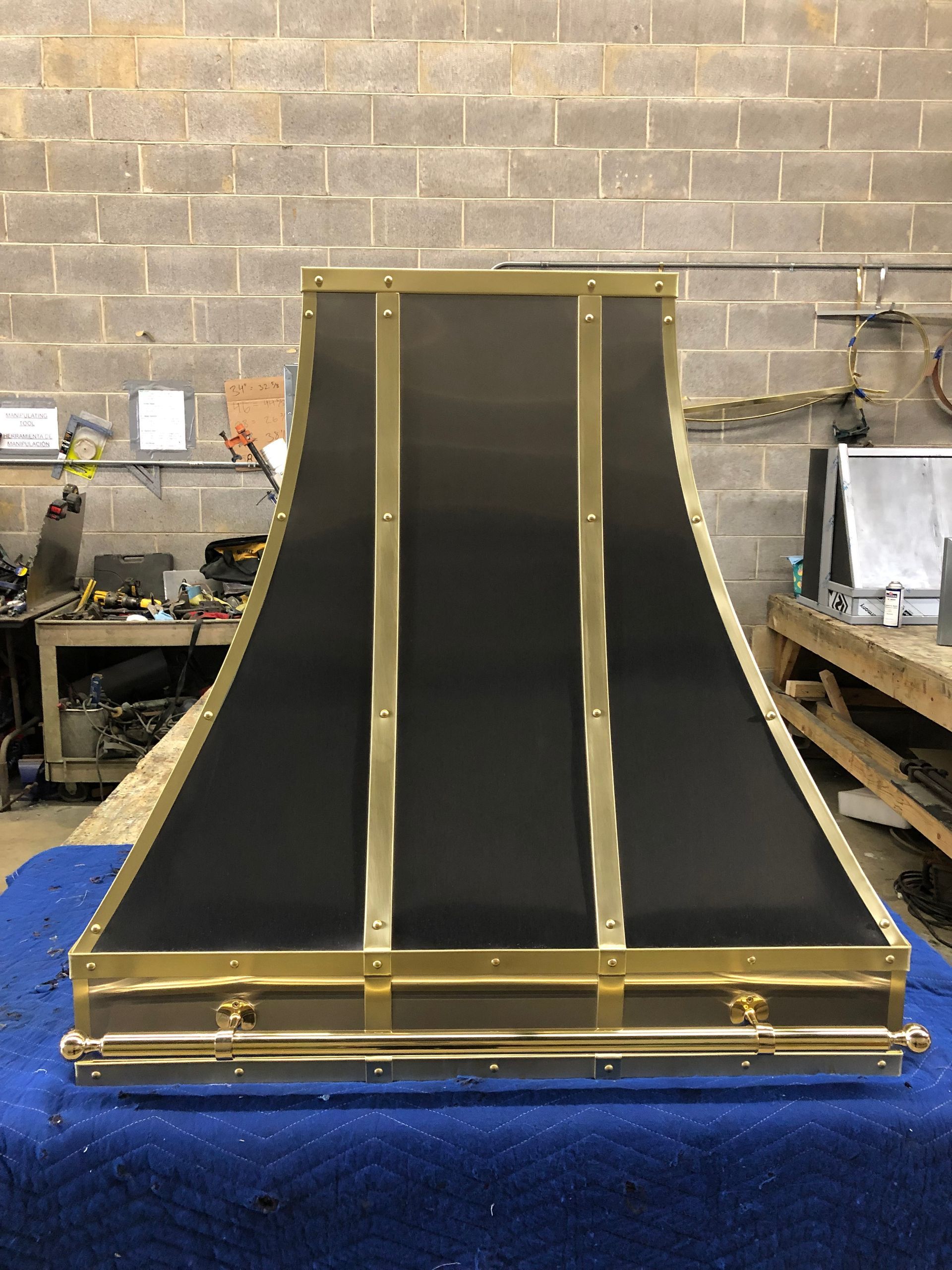 Black carpeted ramp with gold trim in a workshop setting