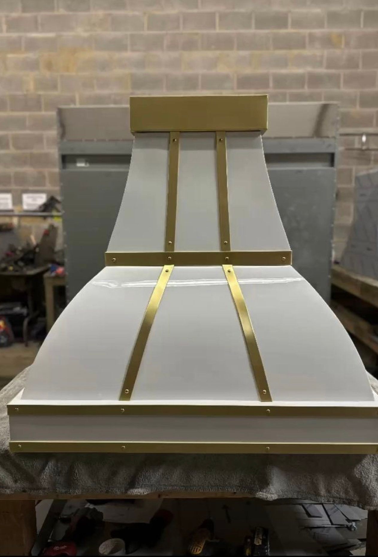 White geometric structure with gold strips in an industrial workshop