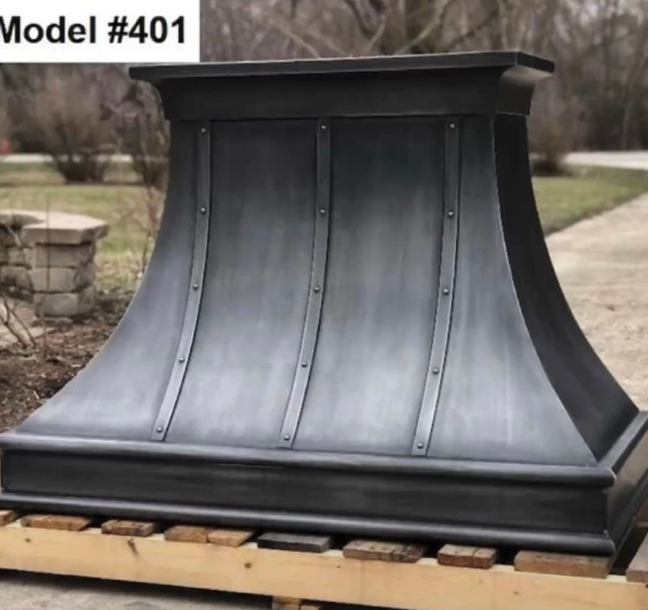 Black metal fireplace hood on wooden pallet outdoors, labeled Model #401