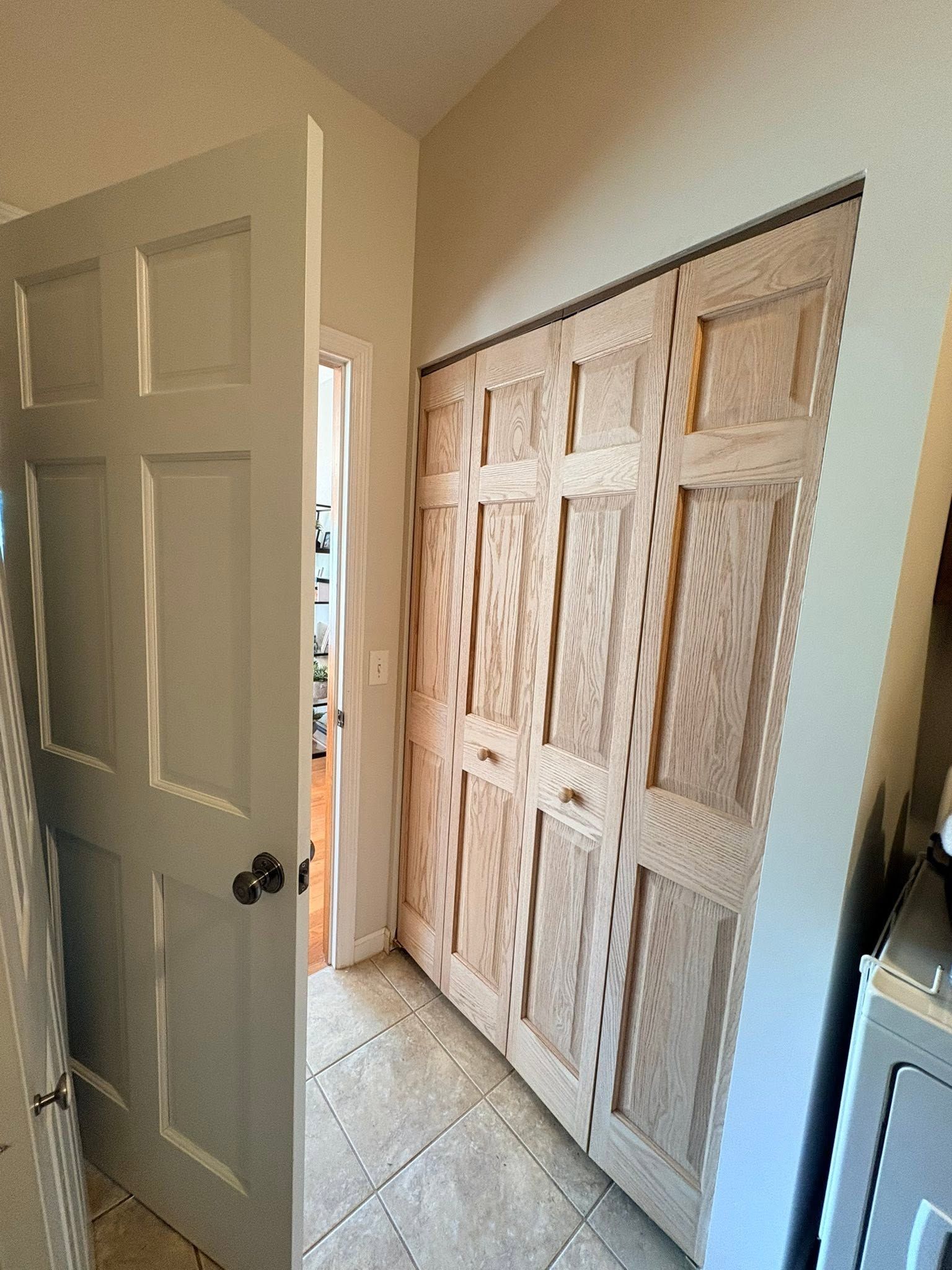 Hallway with a partially open white door and a large sliding barn-style closet door on the right.