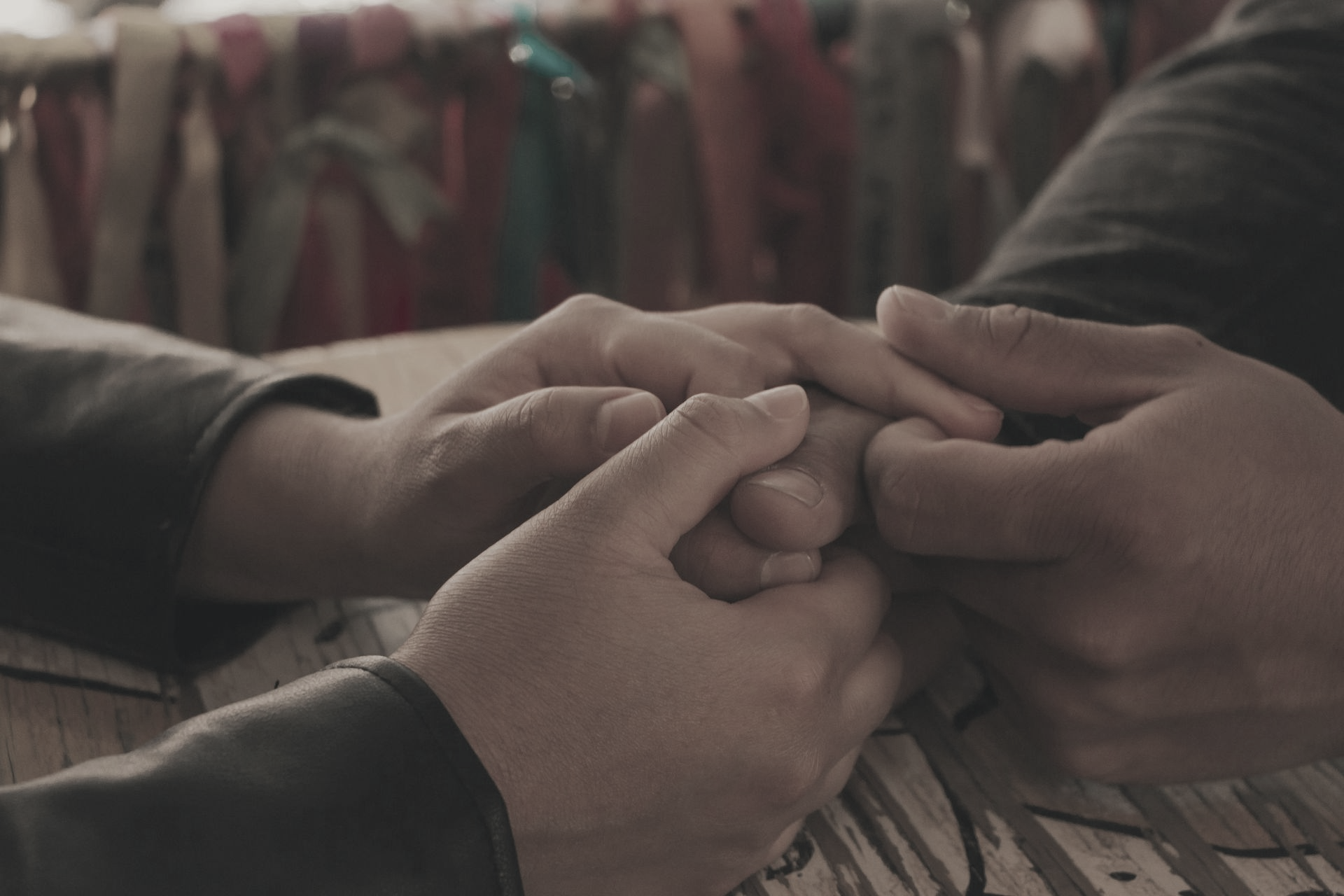 Two hands clasped together, possibly offering comfort or support.