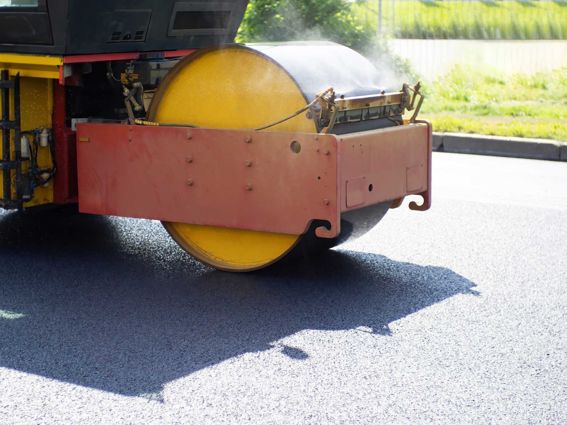 A road roller flattens a road with asphalt. A road roller flattens a road with asphalt.