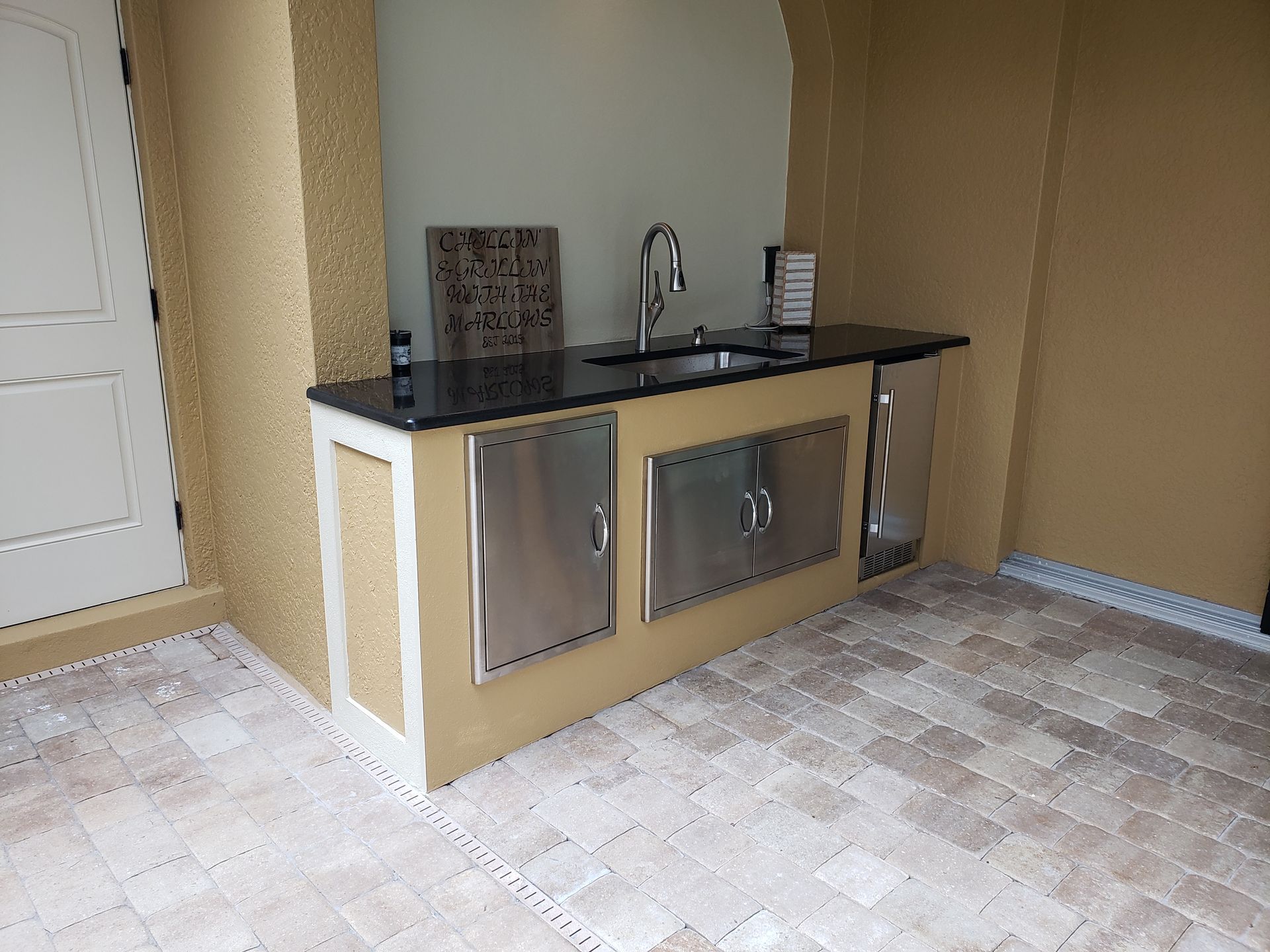 A kitchen with stainless steel cabinets and a sink