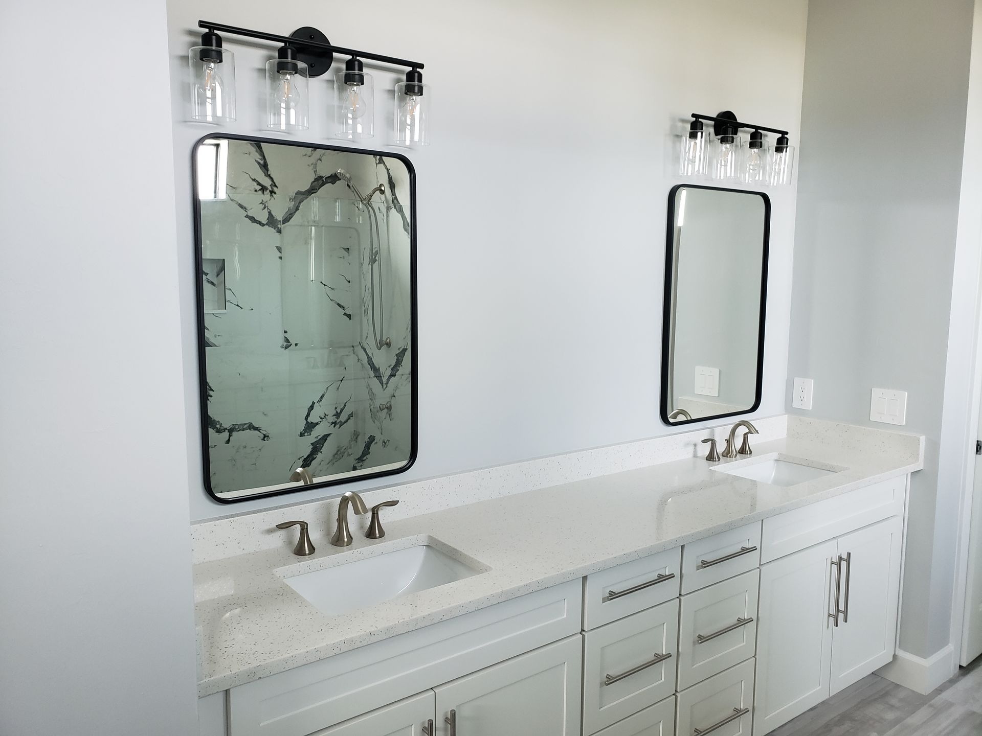 A bathroom with two sinks and two mirrors.