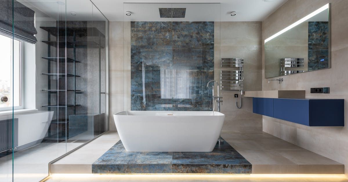 A bathroom with a bathtub , sink , mirror and shower built by Blue Heron Construction Cape Coral