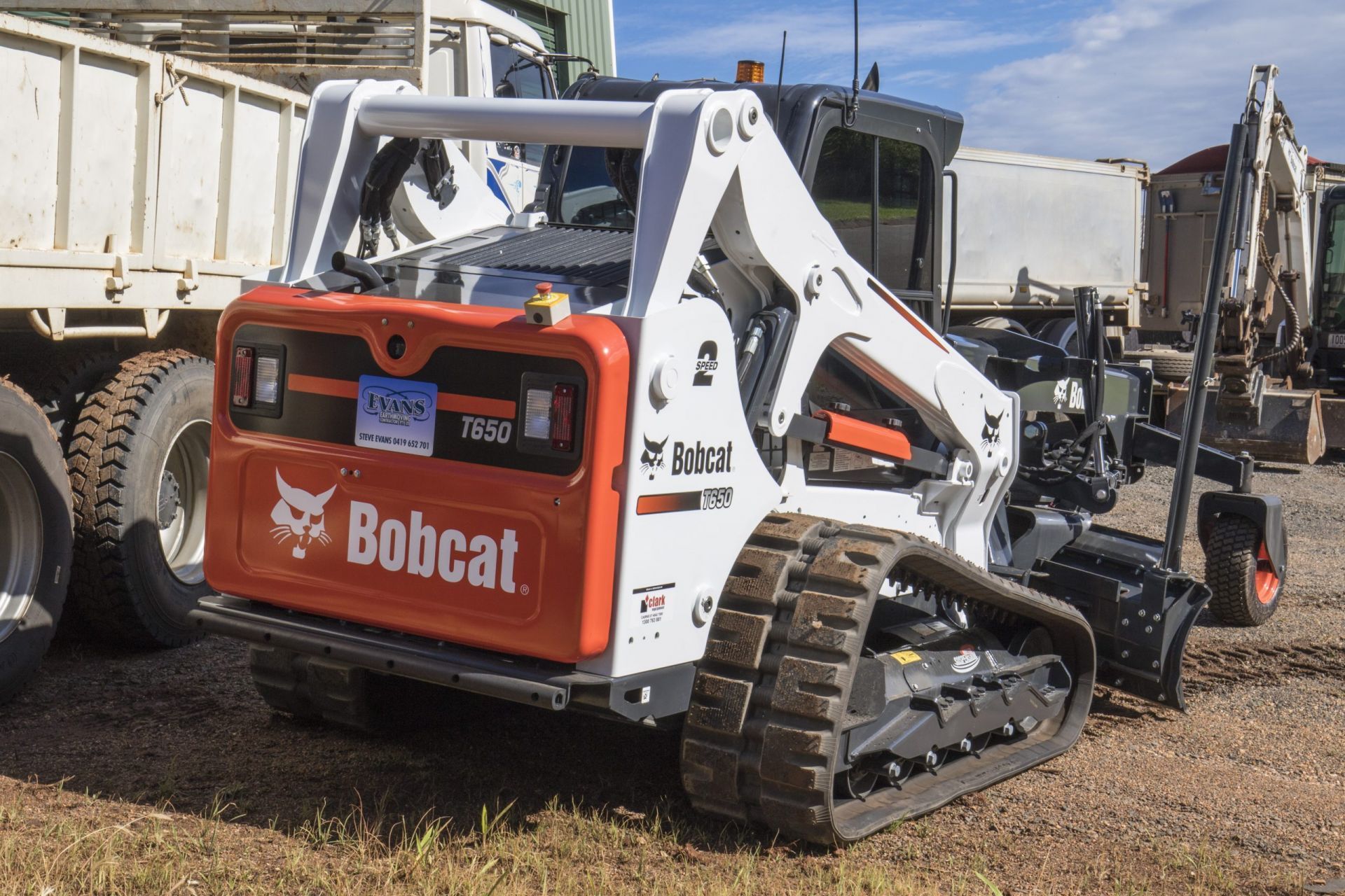 Bobcat T595 Compact Track Loader with Orange and White Details, in A Yard — Evans Earthmoving Contractors In Malanda, QLD 