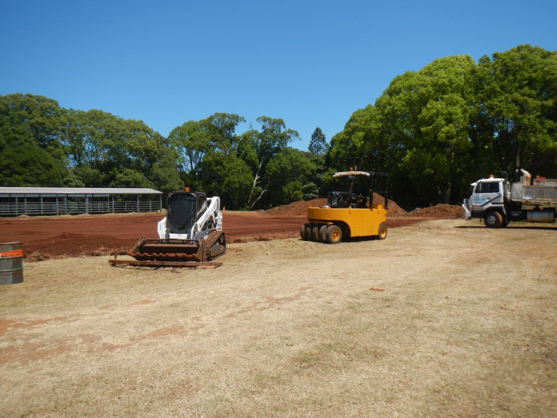 Construction Site with Heavy Machinery, Red Dirt, and A Truck on A Sunny Day — Evans Earthmoving Contractors In Malanda, QLD 