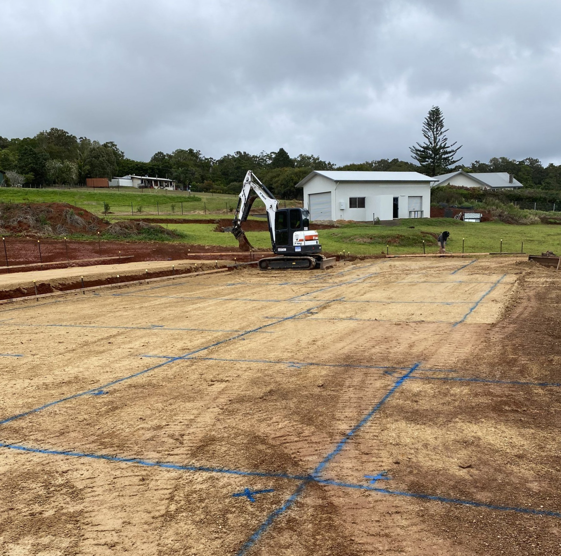 Construction Site with Excavator on Dirt, Marked with Blue Lines — Evans Earthmoving Contractors In Malanda, QLD 