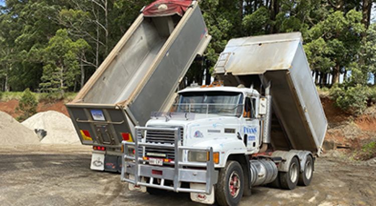 Two Dump Trucks Unloading Gravel At A Construction Site — Evans Earthmoving Contractors In Malanda, QLD 