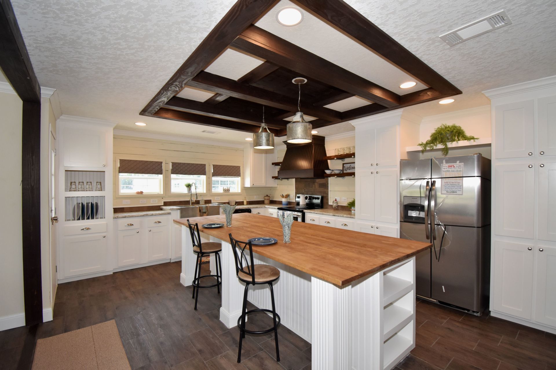 A kitchen with stainless steel appliances and a large wooden island.