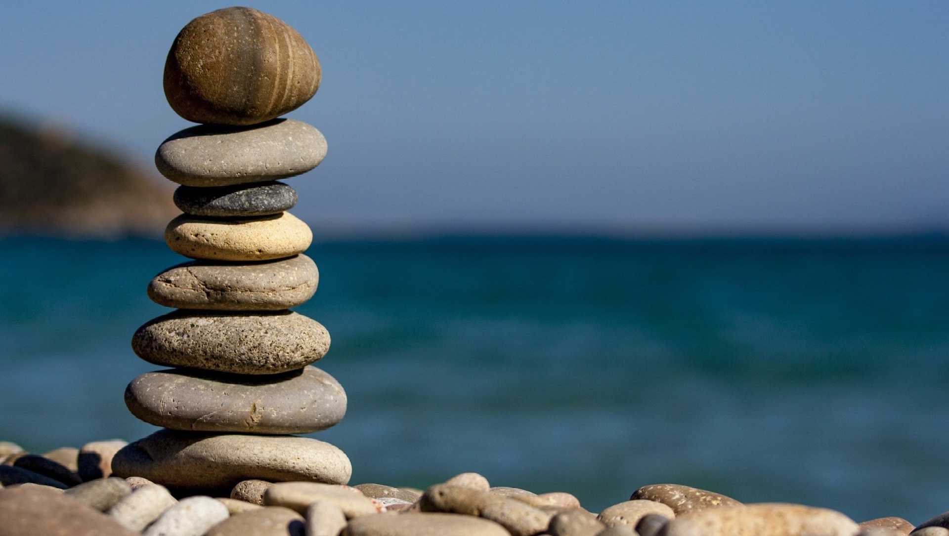 Stack of rocks at a single wide mobile home by the sea