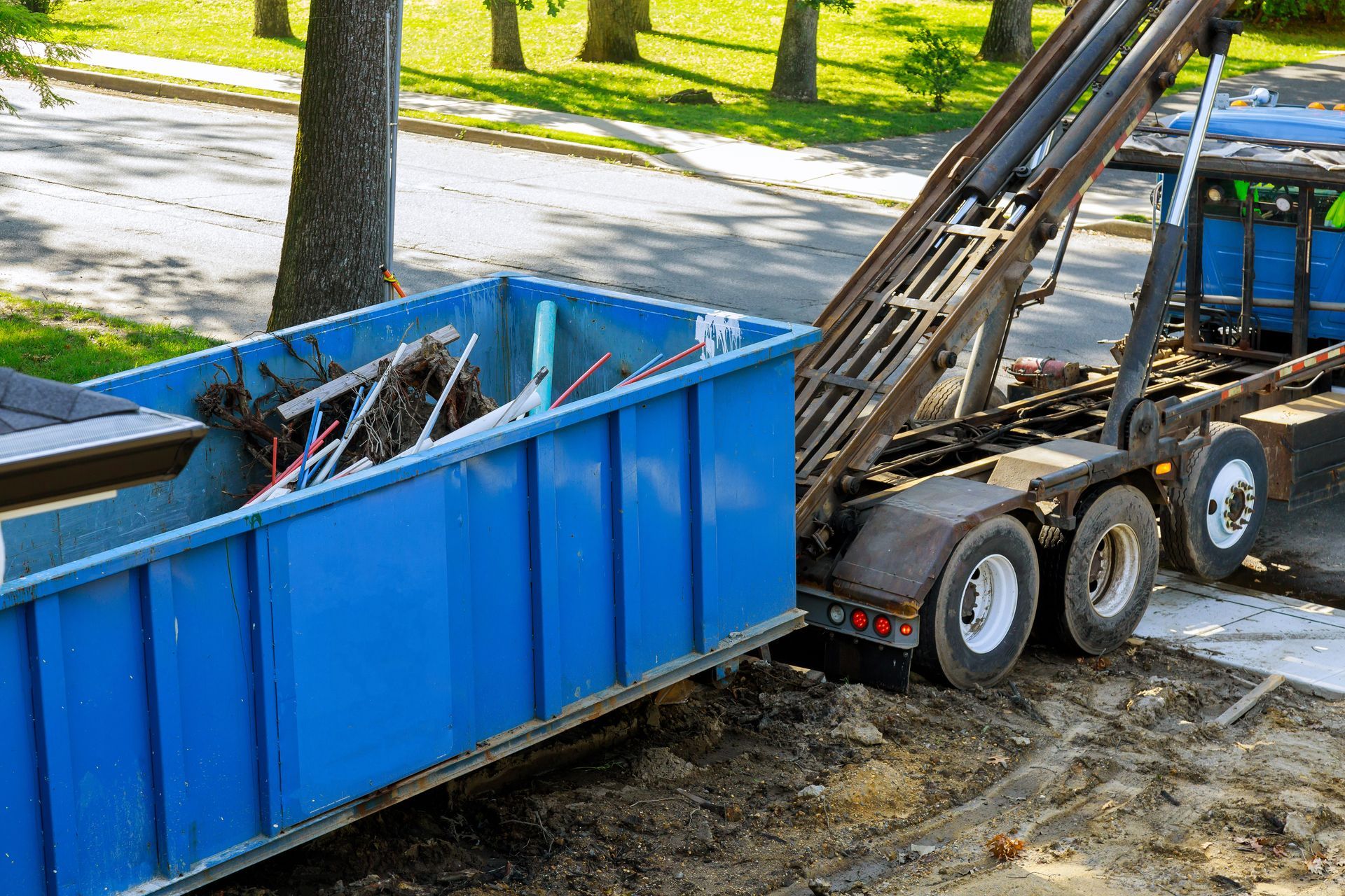 Construction waste being loaded into skip bins during a home renovation. Construction waste being loaded into skip bins during a home renovation.