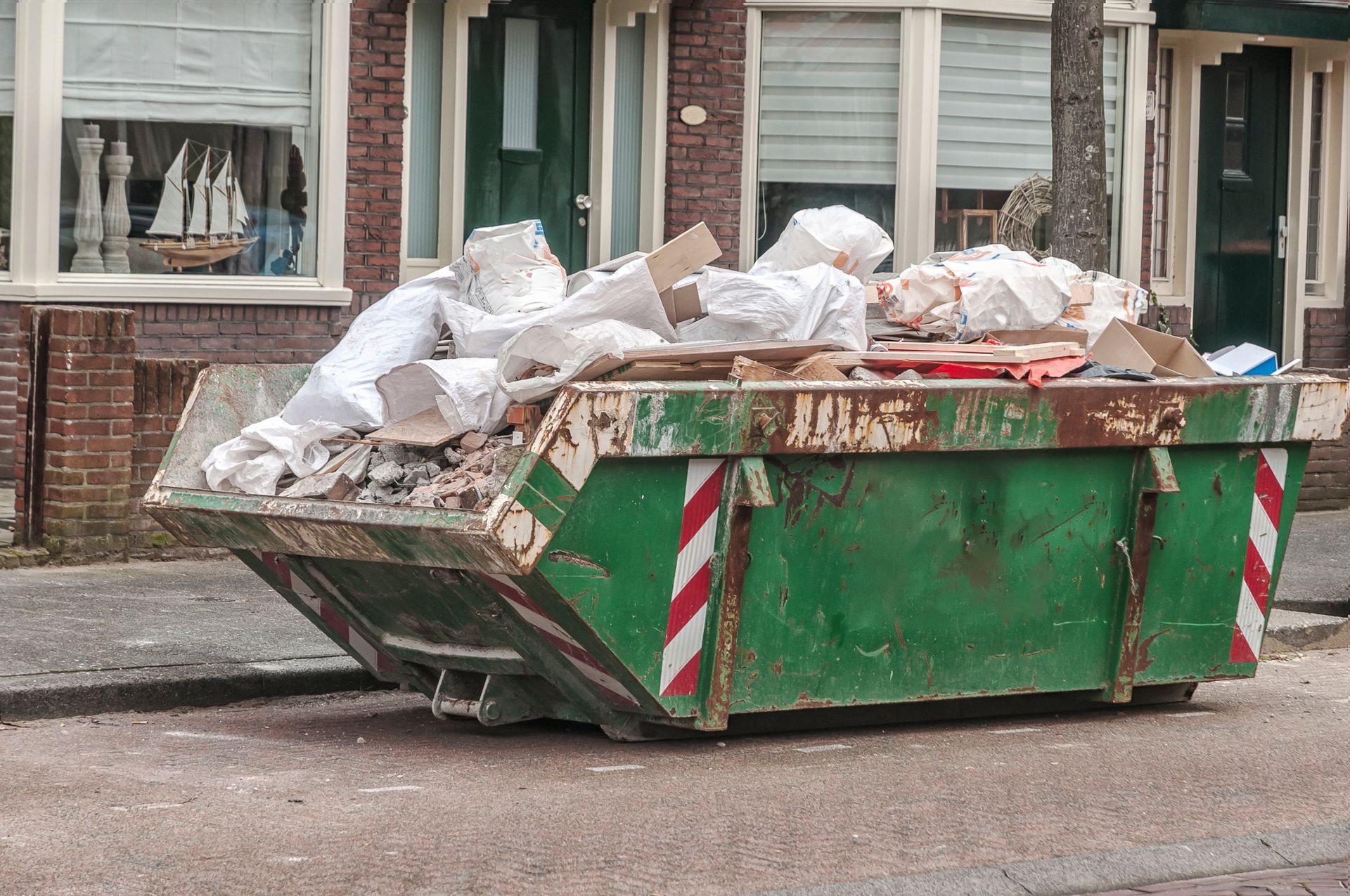 A residential dumpster brimming with garbage, illustrating the need for residential skip bins.