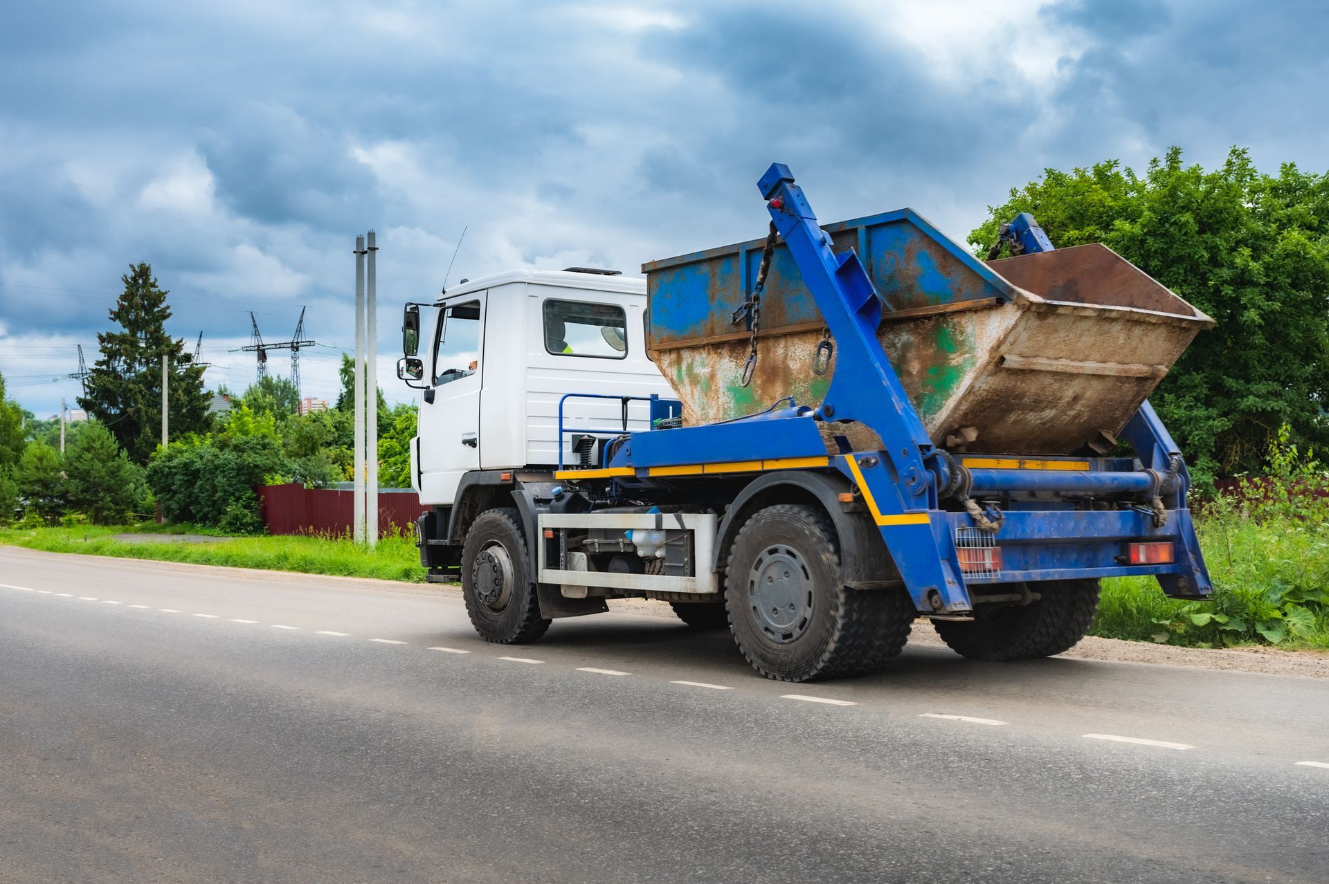 Rubbish removal truck near rural landscape. Rubbish removal truck near rural landscape.