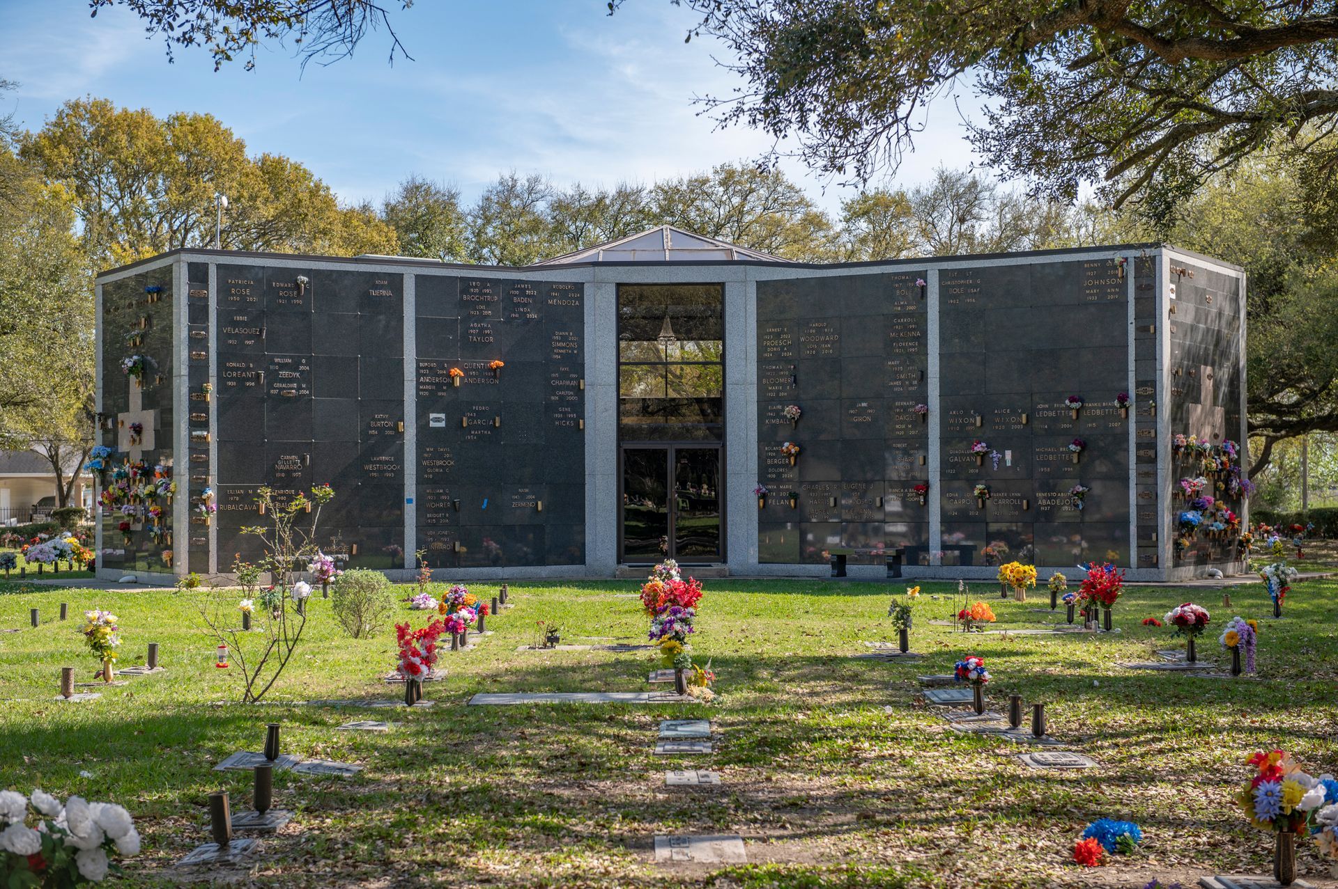 Three gravestones in a cemetery, including names N.D. Smith, Nicholas 1978, and S.F. Johnson 2012.