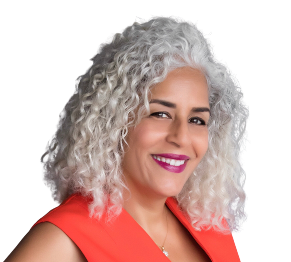 A woman named Rory Lee logo with curly white hair is wearing a red shirt and smiling.