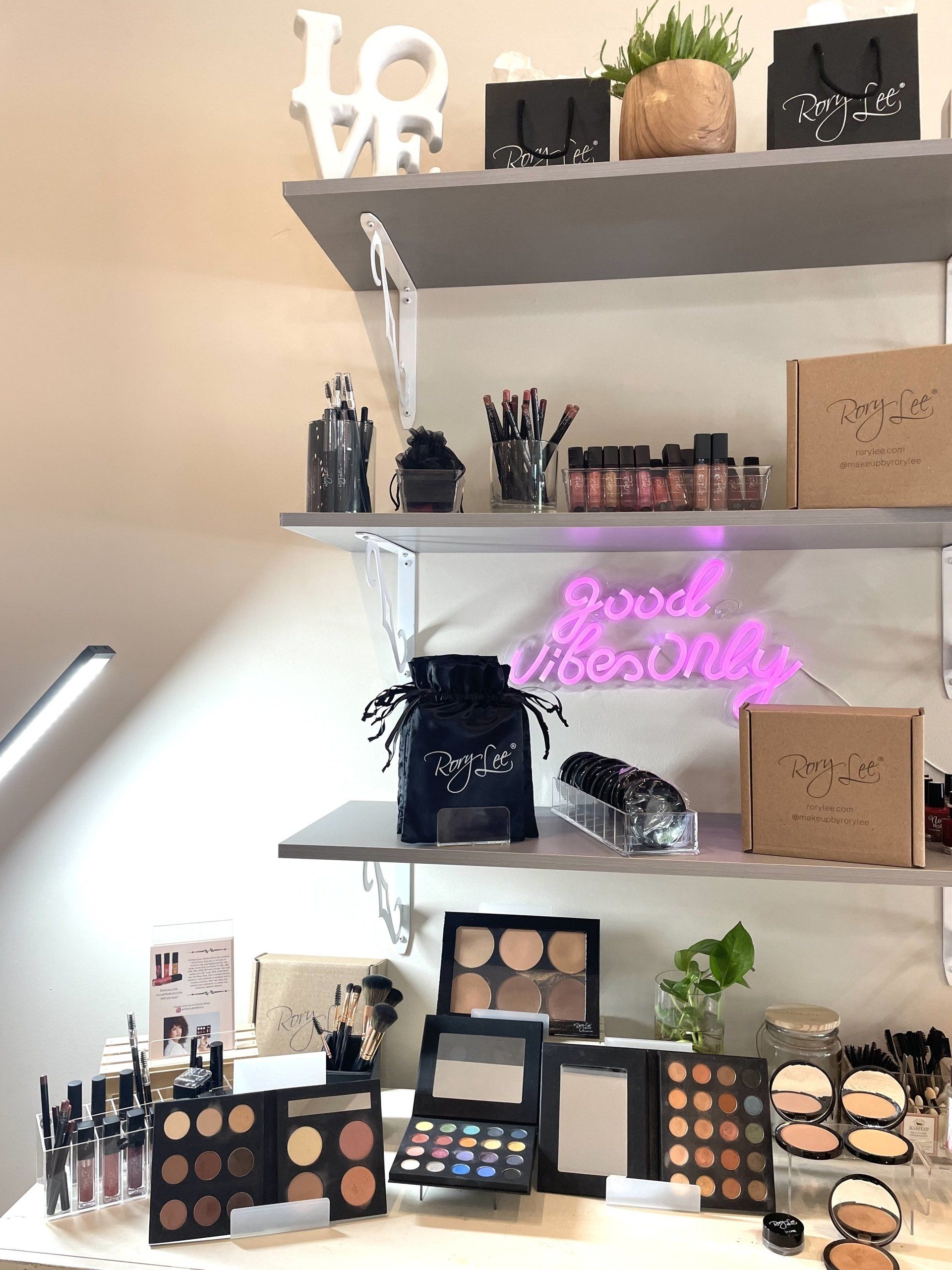 Stand with makeup product by RoryLee Makeup
