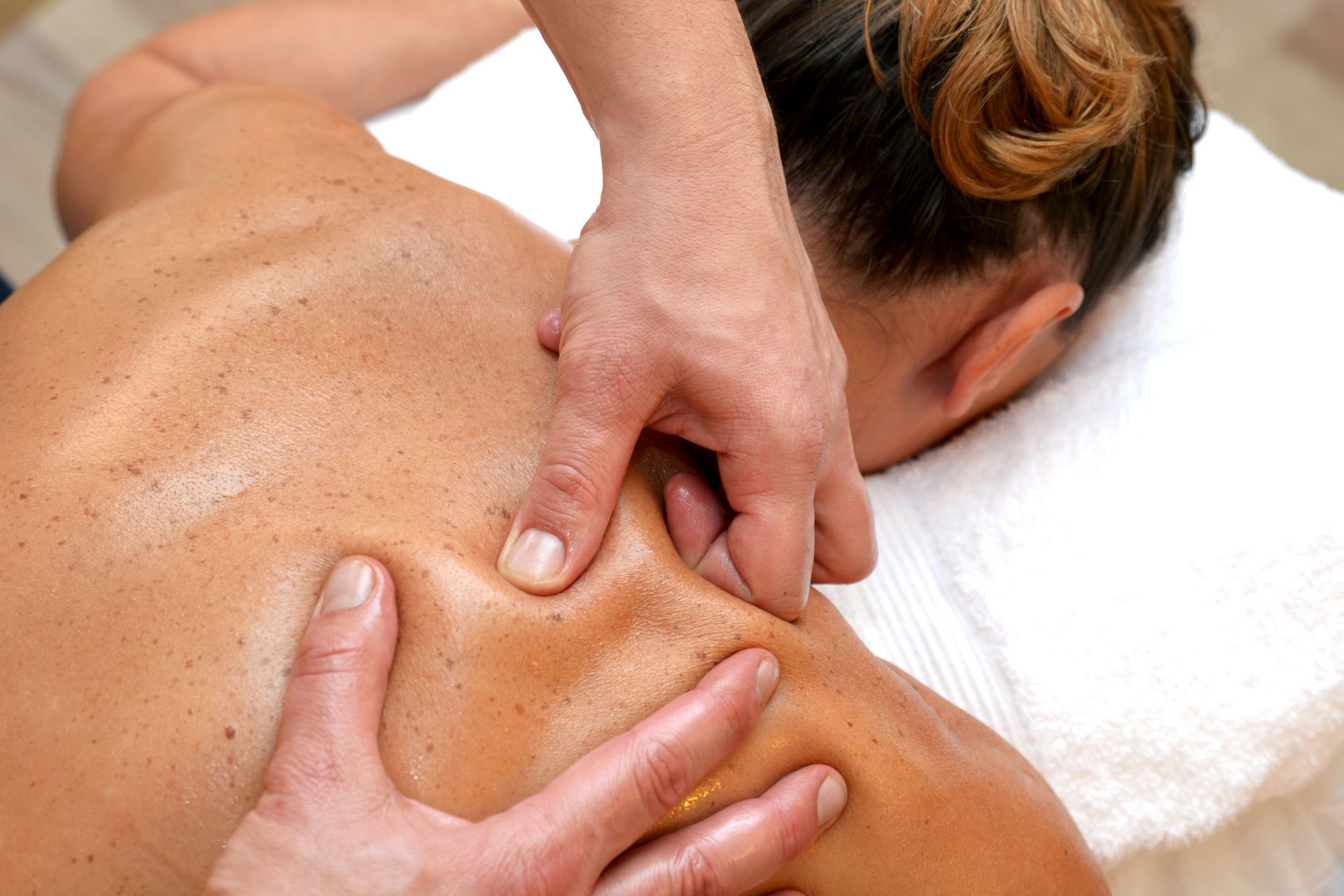 A woman is getting a massage on her back.