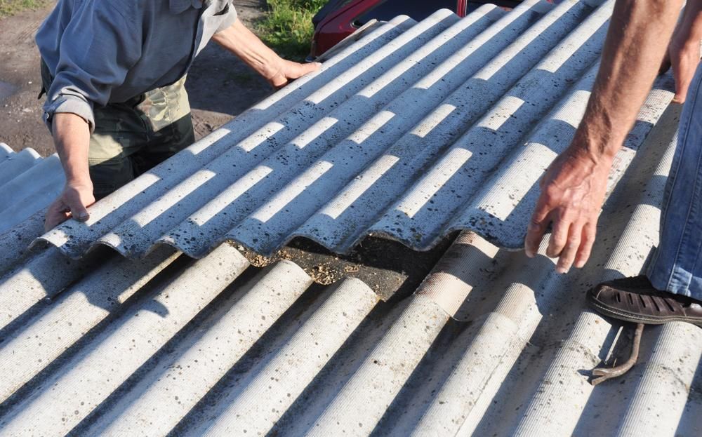 Two People Installing Corrugated Roofing Panels on a Roof — AB QUICK Painting & Maintenance Services In Mareeba, QLD