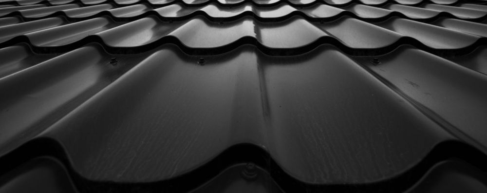 Close-up of a Dark Corrugated Roof, With Repeating Curved Patterns — AB QUICK Painting & Maintenance Services In Mareeba, QLD