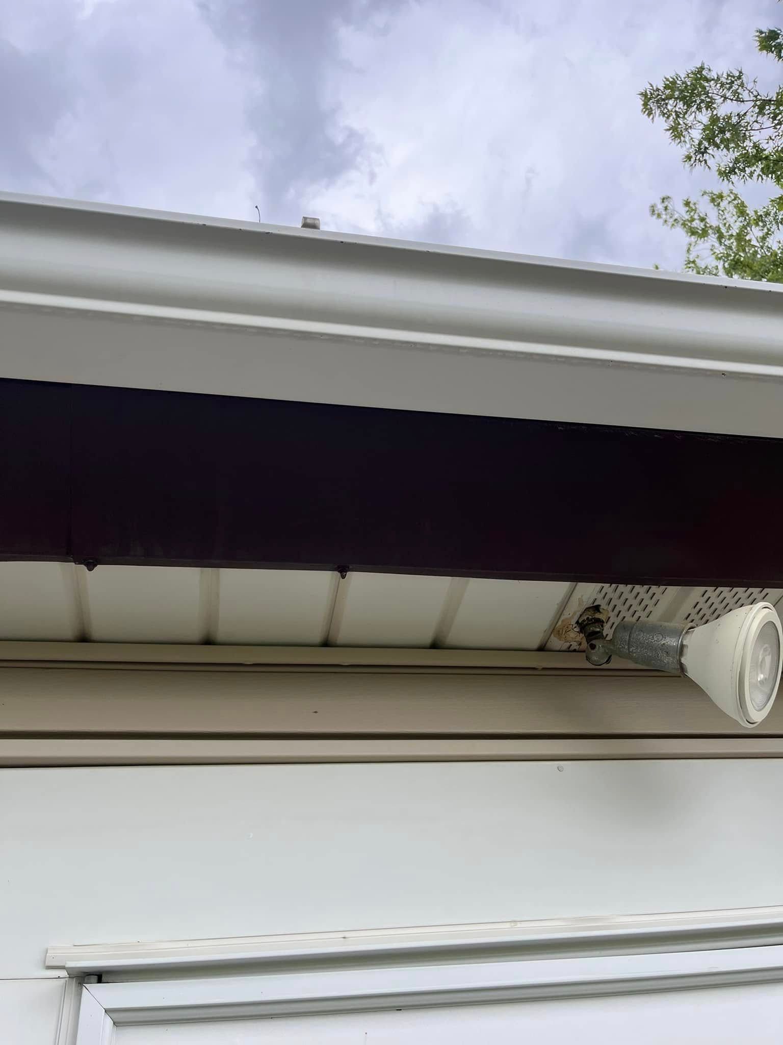 A light is hanging from the roof of a house.