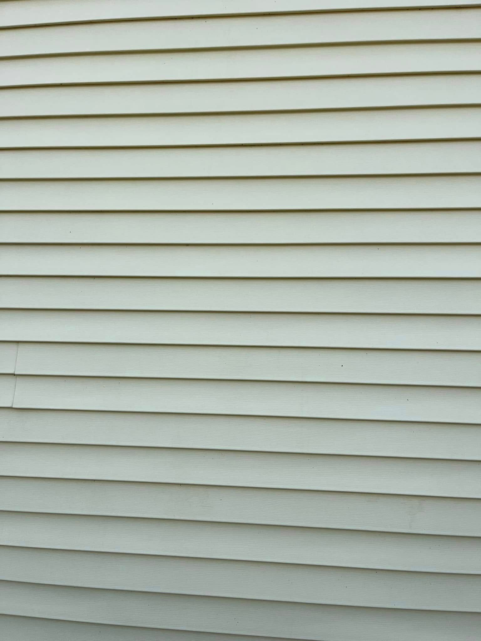 A close up of a white siding on a house.