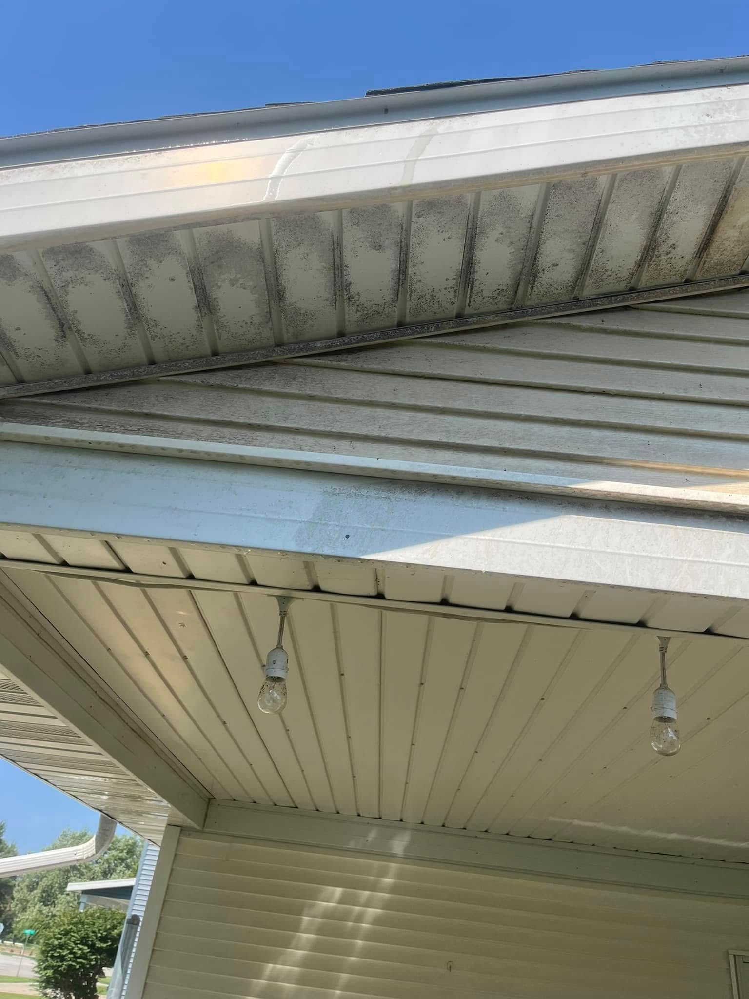 The ceiling of a house with a few lights hanging from it.